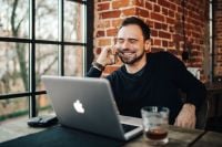 Kaboompics - Young smiling man using mobile phone