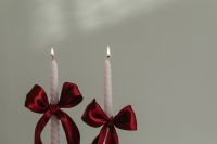 Kaboompics - Two White Taper Candles with Red Satin Bows for Valentine's Day