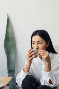 Kaboompics - Woman Relaxing with Coffee in a Japandi Interior