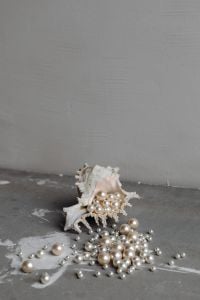 Kaboompics - Loose Pearls Spilling from a Seashell on Gray Concrete