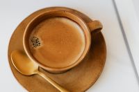Kaboompics - Top-Down Brown Coffee Cup with Golden Spoon