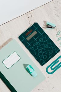 Kaboompics - Notebook and Calculator with Paper Clips, Pencil, Eraser and Sharpener, School Supplies Flat Lay