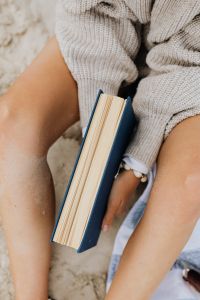 Kaboompics - A woman reads on the beach in the summer