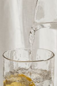 Kaboompics - Close-Up of Water Stream Filling a Citrus Drink