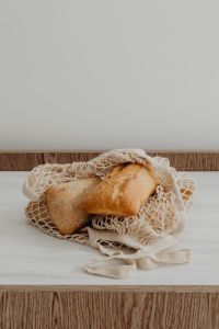 Kaboompics - Fresh Bread Loaves Resting in a Reusable Mesh Bag