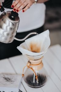 Kaboompics - Woman pouring water in Chemex filter coffee maker