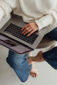 Kaboompics - Top View of Faceless Woman Working on Laptop in White Sweater