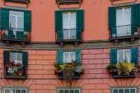 Kaboompics - Close Architectural Detail of a Coral Naples Building With Green Shutters