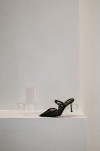 Kaboompics - Single Black Woven Slingback Heel on White Shelf