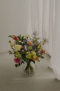 Kaboompics - Colorful Flower Bouquet in a Glass Vase Beside Sheer Curtains
