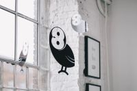 Kaboompics - Little black plastic owls hanging from a ceiling