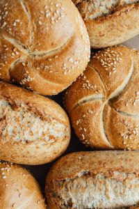 Kaboompics - Overhead Close-Up of Golden Kaiser Rolls with Sesame Seeds, Rustic Bread Texture