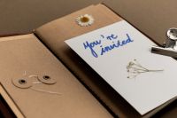 Kaboompics - Handwritten Invitation Card in Open Notebook with Dried Flower
