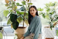 Kaboompics - Portrait of Asian Woman Seated Among Indoor Plants