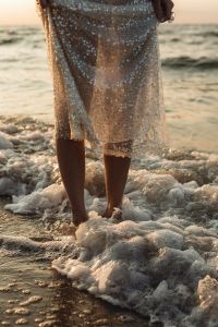 Kaboompics - Barefoot Woman Standing in Sea Foam Wearing Sequin Dress