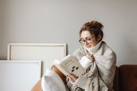 Kaboompics - Woman in Glasses Reading a Book Wrapped in a Blanket