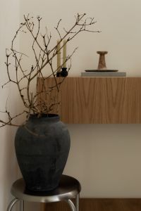Kaboompics - Wabi Sabi Home Decor with Large Branch Vase and Wooden Sideboard
