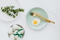 Kaboompics - Easter flat lay with green eggs and fried egg on a plate