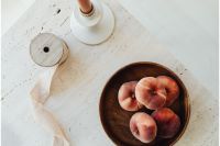 Kaboompics - Bowl of Peaches on Light Table with Minimal Food Styling