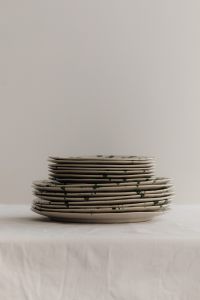 Kaboompics - Paired Green Splatter Plate Stacks in a Neutral Still Life