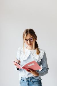 Kaboompics - Student with Glasses Holding Notebook at Home
