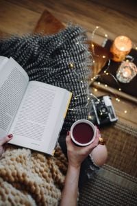 Kaboompics - Woman drinking tea and reading book