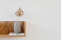 Kaboompics - Dried Fan Palm Leaf in Ceramic Vase on Oak Floating Shelf