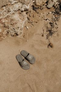 Kaboompics - Beige Minimalist Slides on Sand with a Rock Backdrop