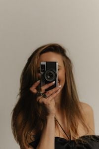 Kaboompics - Woman Taking a Photo with a Compact Camera