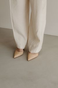 Kaboompics - Beige Pointed Heels with White Wide-Leg Trousers