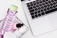 Kaboompics - Close-Up Shopping Basket with Beauty Products and Laptop