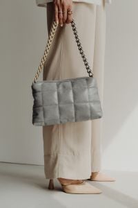 Kaboompics - Gray Quilted Mini Bag with Chain Strap Styled against an Ivory Outfit