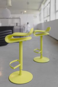 Kaboompics - Lime Yellow Designer Bar Stools in a Contemporary Furniture Showroom, Vertical Interior Photo
