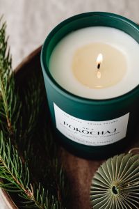 Kaboompics - Green Candle with Paper Ornaments on Wooden Tray