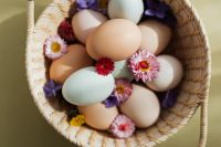 Kaboompics - Wicker Easter Basket Filled with Pastel Eggs, Daisies and Purple Flowers
