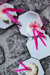 Decorative white pumpkin trinkets with ribbons on the floor