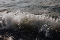 Kaboompics - Curved Wave Crest and Foam Close-Up, Dark Ocean Texture