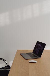 Kaboompics - Laptop And White Mouse On Wooden Desk With Empty Chair