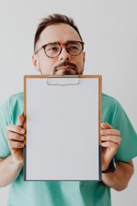 Kaboompics - Close-Up of Doctor Holding Blank Clipboard