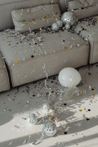 Kaboompics - Gray Sofa with Disco Balls, Confetti and a Happy New Year Balloon
