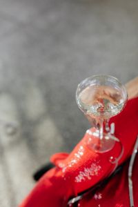Kaboompics - Woman in red pants is sitting on a chair with glass