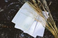 Kaboompics - Stacked White Postcards and Dried Wheat on Marble
