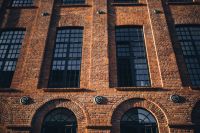 Kaboompics - Close-Up of Arched Windows on a Sunlit Brick Facade