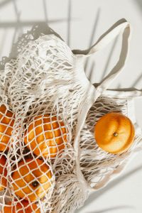 Kaboompics - Close-Up of Citrus and Cotton Mesh Produce Bag Texture in Natural Light