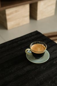 Kaboompics - Espresso in Glass Cup on Black Textured Side Table