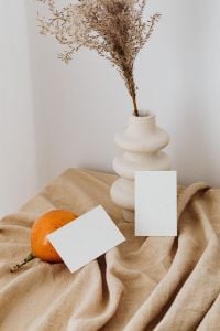Kaboompics - Minimal Dried Florals in a White Vase with Orange and a Blank Branding Card