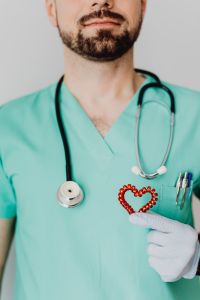 Kaboompics - Doctor Pointing to Heart-Shaped Medical Symbol