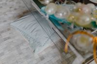 Kaboompics - Glass Coffee Table Decor with Crystal Orbs and Soft-Focus Blue Sofa Cushions