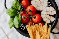 Kaboompics - Wide Flat Lay of Pasta Ingredients with Cherry Tomatoes and Basil