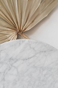 Kaboompics - Fan-Shaped Dried Palm Leaf over Marble for Botanical Home Decor